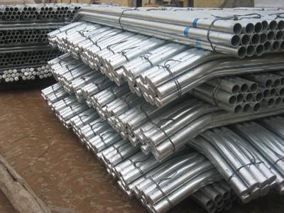 bundles of galvanized bended round post placed in the storehouse