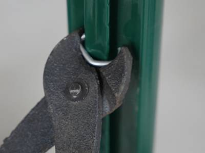 A pair of pliers are fix the C ring onto D shaped post.