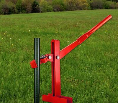 A red post puller is uninstalling the U channel sign post.