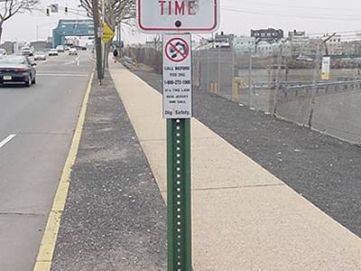 a traffic signboard fixed by green PVC coated U post