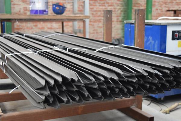 Several black bitumen Y posts on the metal pallet.